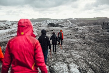 A group hiking in a line on Svínafellsjökull Glacier in the Skaftafell National Park Iceland. This glacier has been used as a filming location for many feature films.